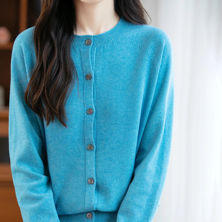 Blue cardigan worn by a person with a neutral background