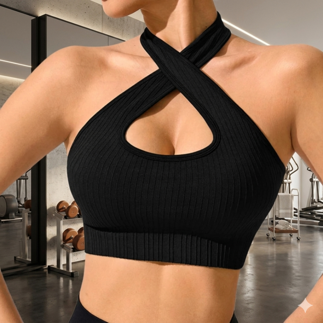 Person wearing a black ribbed sports bra in a gym setting
